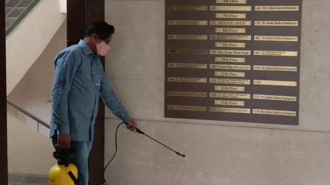 Technician performing pest control in a building